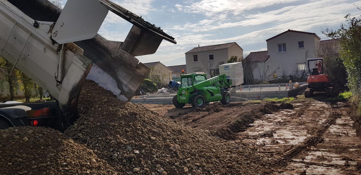 Livraison de remblai par camion benne, chariot télescopique et mini-pelle sur un chantier de fondations